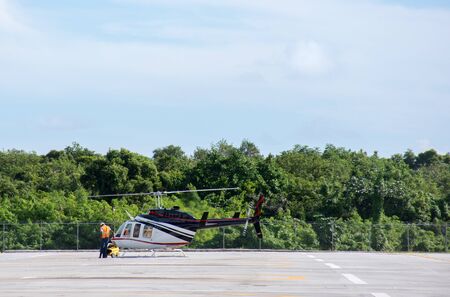 The helicopter is being prepared for take-off, stands on a helipad withの写真素材
