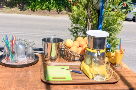 On a sunny day there is a table with vozhmylkoy oranges and lemons.の写真素材