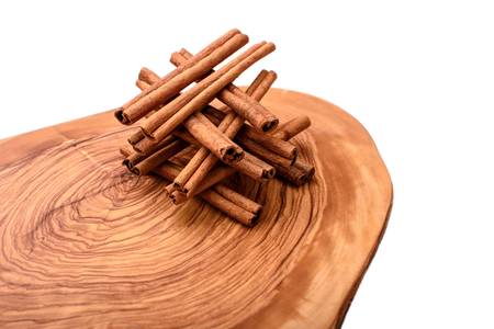 Cinnamon on wooden board isolated on white background.の写真素材