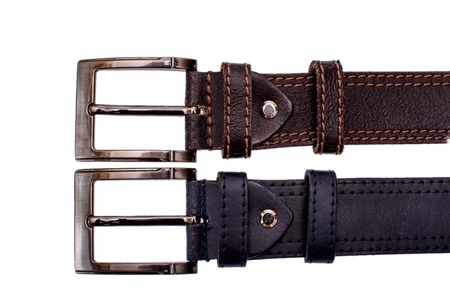 Several fashionable men's leather belts gray brown isolated on white background.の写真素材
