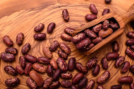 Peanut nut is on an olive board and next is an olive scoop.の写真素材