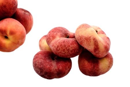 Ripe sweet flat peaches and round peaches isolated on white background.の写真素材
