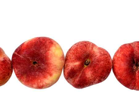 Sweet sweet flat peaches isolated on white background.の写真素材