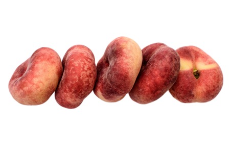 Sweet sweet flat peaches isolated on white background.の写真素材