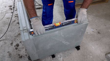 The worker stacks the unit, and checks the level.の写真素材