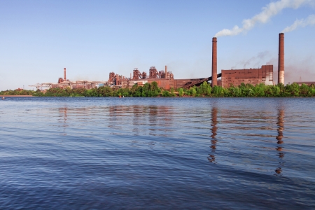 Panorama of metallurgical works reflected on water. Industrial landscapeの写真素材