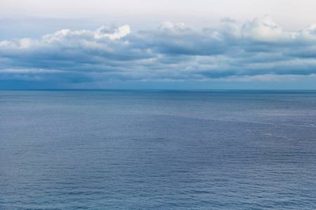 Marine landscape with clouds in a blue toneの写真素材