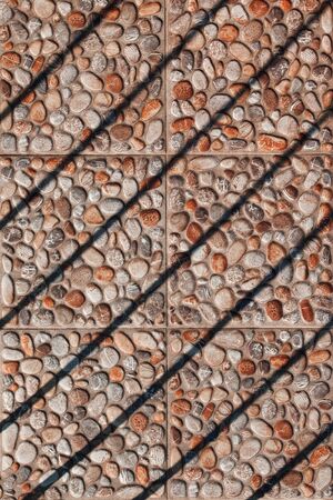 Paving slabs pebble in bright sunlight, harsh shadowsの写真素材