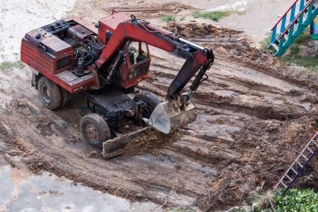 Old excavator at work, a top viewの写真素材