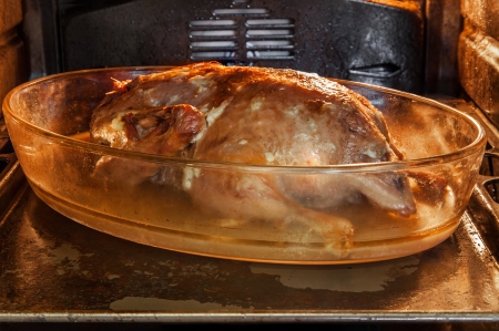 Peking duck stuffed with apples in gas ovenの写真素材