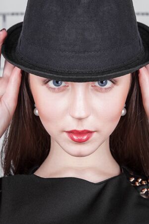 Portrait of glamour stylish young female with fashionable female hat