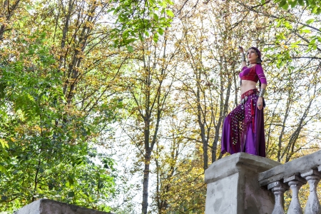 Oriental dancer with saber in the parkの写真素材