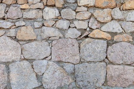 Old stone masonry of granite, grunge background