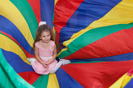 Happy cute curly baby girl at children's festivalの写真素材