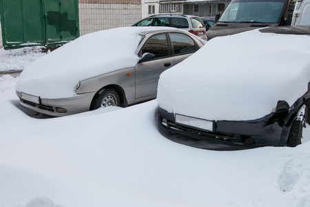 Cars covered in snow in the parking lot after a blizzardの写真素材