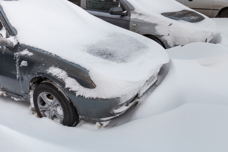 Car stuck in snow after snowstorm in the winterの写真素材
