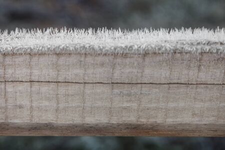Wooden plank covered with frost closeup outdoors, abstract winter backgroundの写真素材