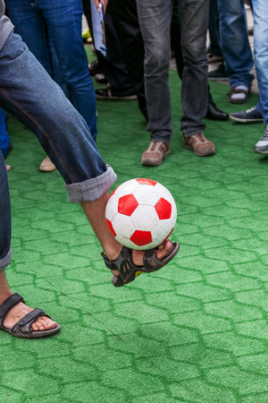 Man juggling a soccer ball, a competition among fansの写真素材
