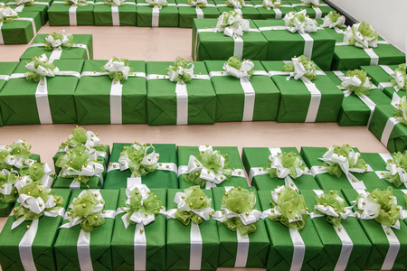 Lot of green gift boxes with white ribbon and bowの写真素材