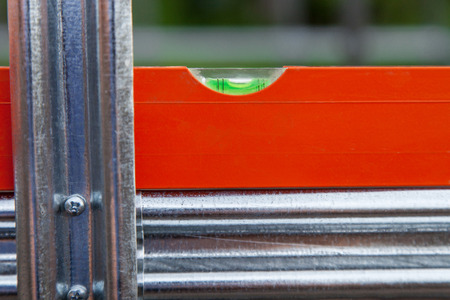 Spirit level, installation of metal construction close-upの写真素材