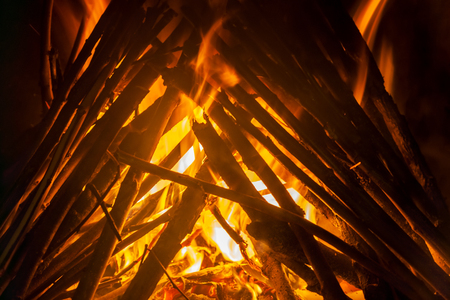 Burning wood in the fireplace close-up, flame texture, fire backgroundの写真素材