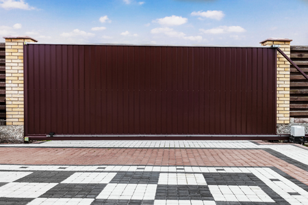 Modern garage door isolated on blue sky background with clipping paths.Large automatic sliding...