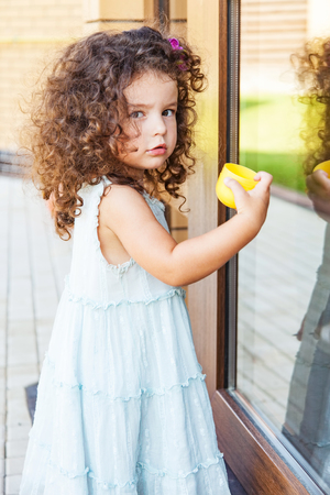 Little girl knocks on the closed doorの写真素材