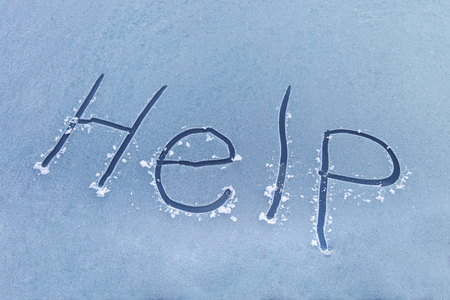 Word help written on the windshield of frozen car in winter, outdoorsの写真素材