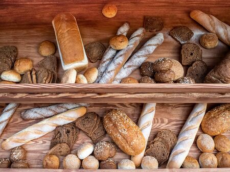 Batch of fresh baked buns and loafs on a market counter