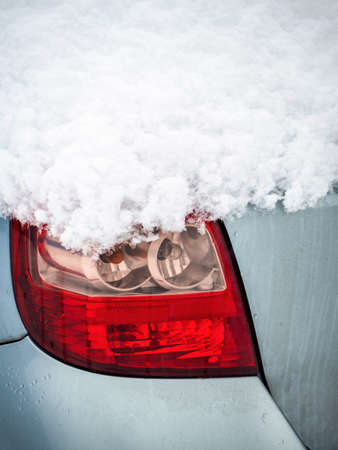 Rear light of modern car covered with snow in winterの写真素材