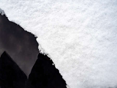 Snow cover on dark glass, abstract natural backgroundの写真素材