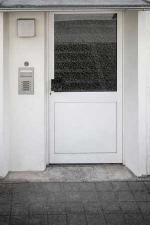 White plastic doors with frosted glass, residential building entrance