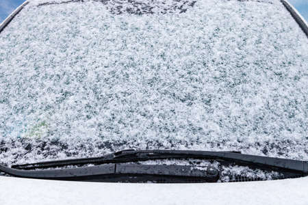 Frozen front windshield of car during winter morningの写真素材