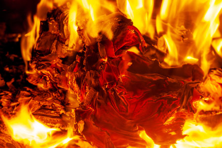 Burning paper in the fireplace, fire and ashの写真素材