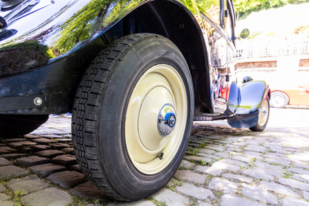 Rear wheel of a vintage black retro mobile close-up