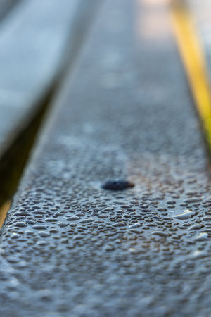 Dew drops on a painted wooden surface, abstract background, shallow depth of field