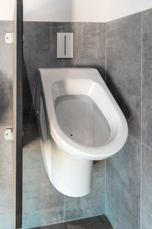 White porcelain urinal in public toilets close up