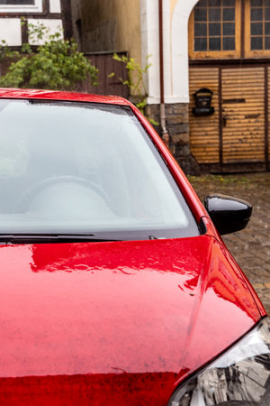 Car stands in heavy rain on the city streetの写真素材