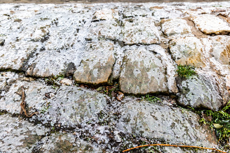 The surface of the cobblestones is covered with ice, icy conditions, black iceの写真素材