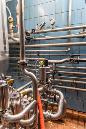 System of steel pipes in food and drink processing plant. Pipelines in brewery factoryの写真素材