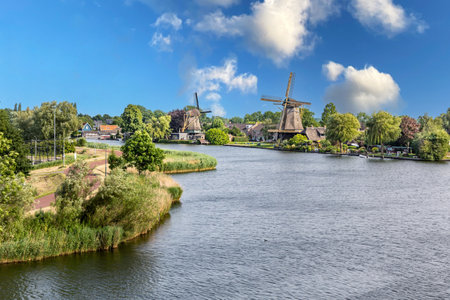 Historic wooden windmill on the canal bank in Weesp, Netherlandsの写真素材