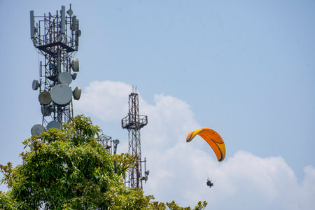 Paraglider flying in the blue sky with white clouds.の写真素材