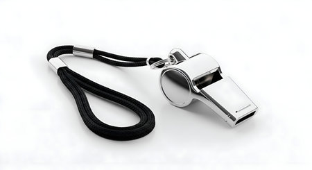 A single basketball coach whistle with lanyard, placed neatly on white surfaceの素材