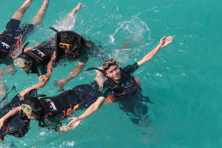 Use a floating kit to float on the sea front,beautiful ocean. Holiday, vacation, travel, diving, tourism with friends.の写真素材