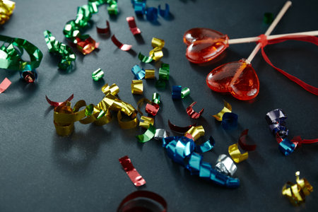 Heart-shaped sweets on a stick. Valentine's Day. Background. Candy on black background