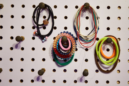 Multicolored hair ties hang on hooks