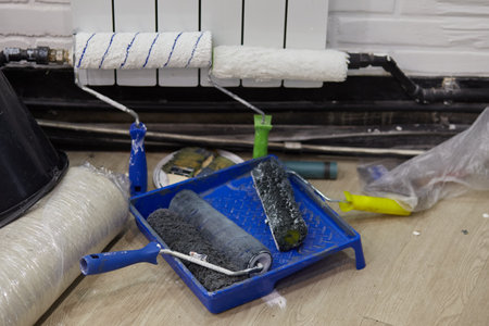 Rolls for painting the walls are in the carriage. Home repairs. Painting tools