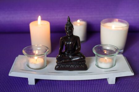 Candles and buddha in relaxation spaceの写真素材