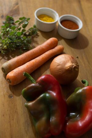 vegetables and spices on woodの写真素材