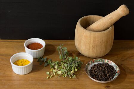 Spices and mortar on wooden tableの写真素材